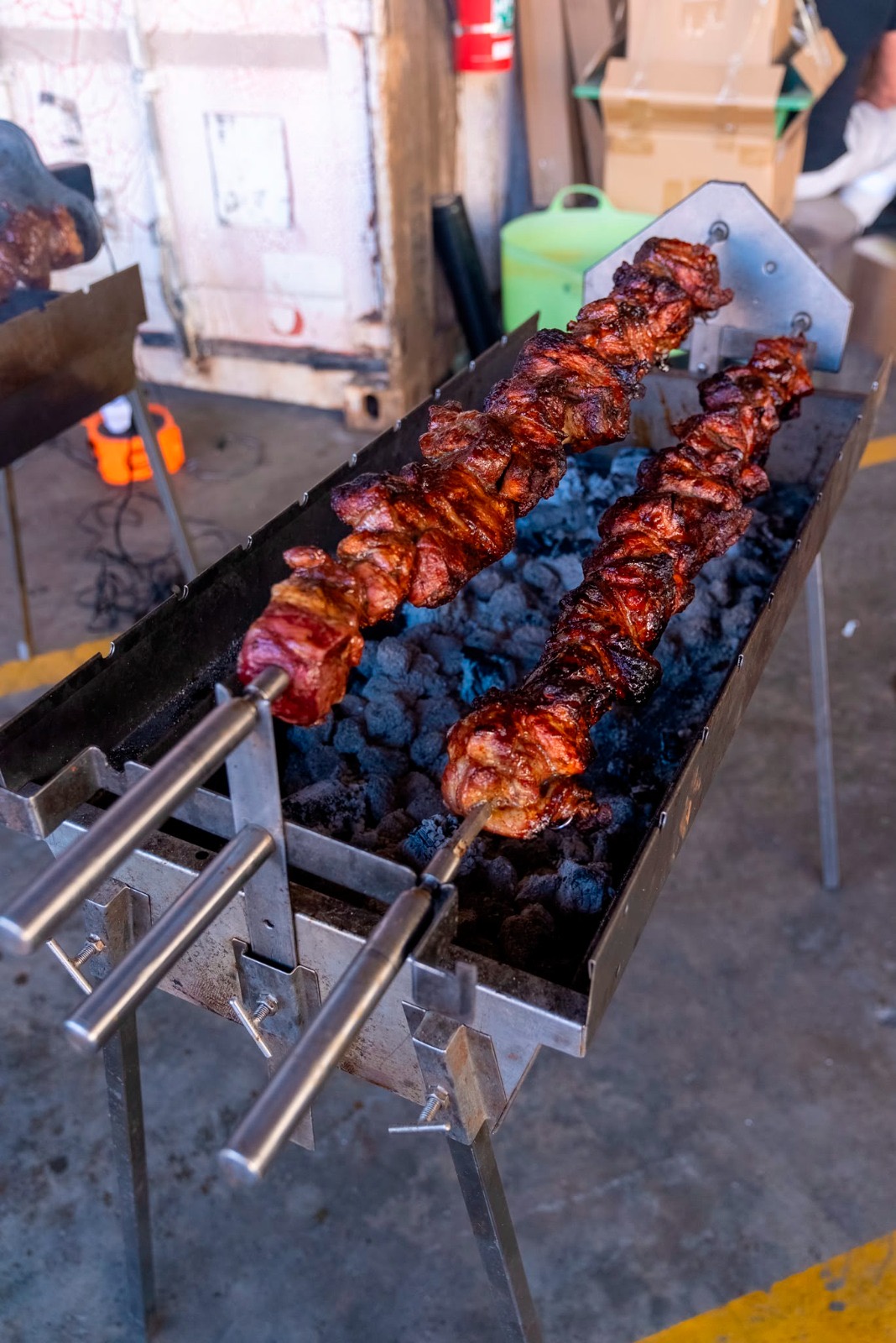 Kontosouvli turning on the spit over a charcoal trough